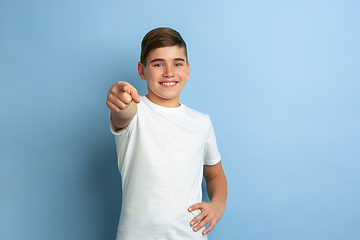 Image showing Caucasian teen\'s portrait isolated on blue studio background