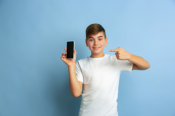 Image showing Caucasian teen\'s portrait isolated on blue studio background