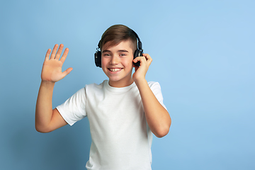 Image showing Caucasian teen\'s portrait isolated on blue studio background