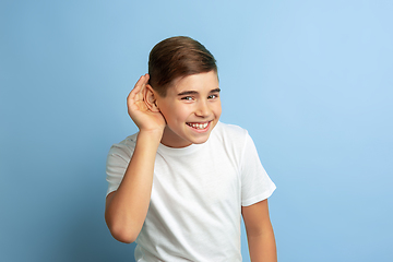 Image showing Caucasian teen\'s portrait isolated on blue studio background