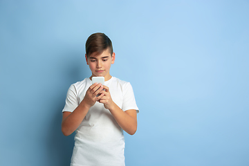 Image showing Caucasian teen\'s portrait isolated on blue studio background