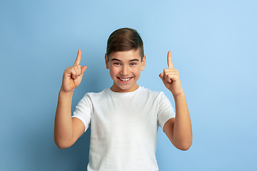 Image showing Caucasian teen\'s portrait isolated on blue studio background