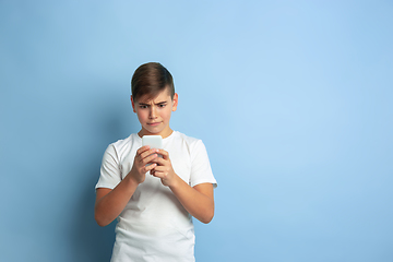 Image showing Caucasian teen\'s portrait isolated on blue studio background