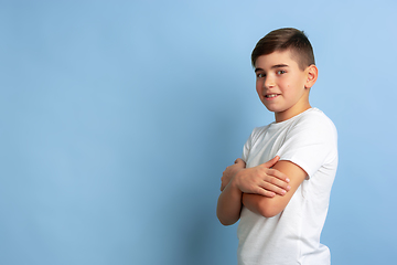 Image showing Caucasian teen\'s portrait isolated on blue studio background