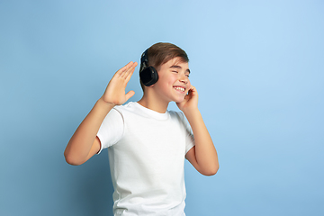 Image showing Caucasian teen\'s portrait isolated on blue studio background