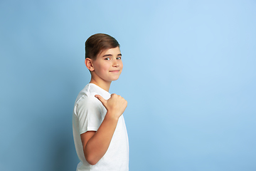 Image showing Caucasian teen\'s portrait isolated on blue studio background