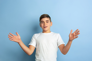 Image showing Caucasian teen\'s portrait isolated on blue studio background