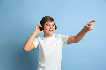 Image showing Caucasian teen\'s portrait isolated on blue studio background