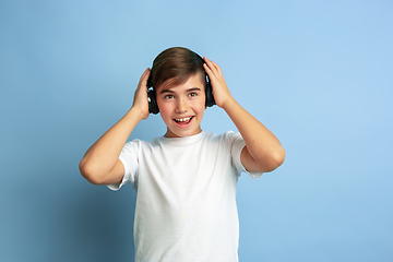 Image showing Caucasian teen\'s portrait isolated on blue studio background