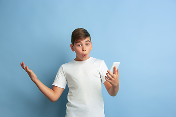 Image showing Caucasian teen\'s portrait isolated on blue studio background