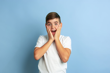 Image showing Caucasian teen\'s portrait isolated on blue studio background