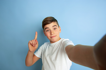 Image showing Caucasian teen\'s portrait isolated on blue studio background