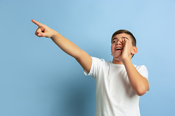 Image showing Caucasian teen\'s portrait isolated on blue studio background