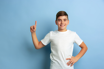 Image showing Caucasian teen\'s portrait isolated on blue studio background