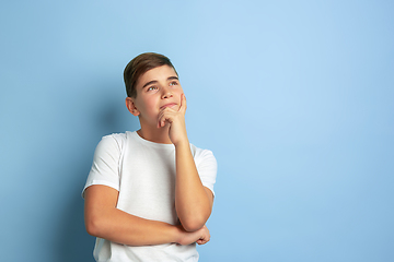 Image showing Caucasian teen\'s portrait isolated on blue studio background