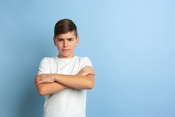 Image showing Caucasian teen\'s portrait isolated on blue studio background