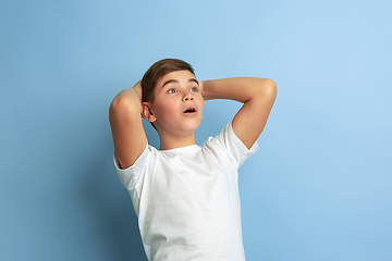 Image showing Caucasian teen\'s portrait isolated on blue studio background