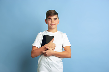 Image showing Caucasian teen\'s portrait isolated on blue studio background