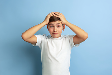 Image showing Caucasian teen\'s portrait isolated on blue studio background