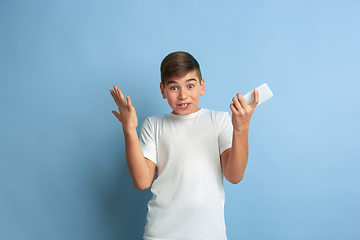 Image showing Caucasian teen\'s portrait isolated on blue studio background