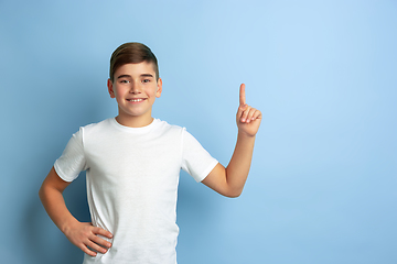 Image showing Caucasian teen\'s portrait isolated on blue studio background