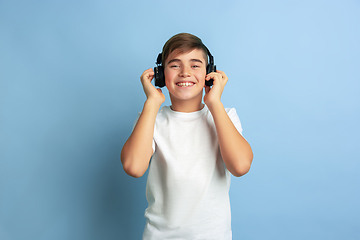 Image showing Caucasian teen\'s portrait isolated on blue studio background