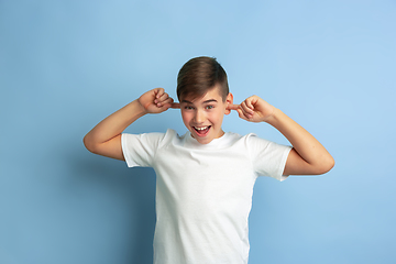 Image showing Caucasian teen\'s portrait isolated on blue studio background