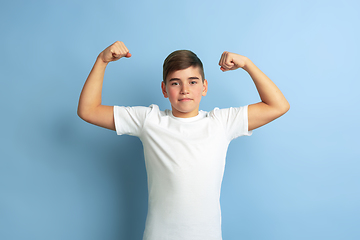 Image showing Caucasian teen\'s portrait isolated on blue studio background