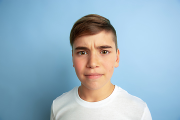 Image showing Caucasian teen\'s portrait isolated on blue studio background