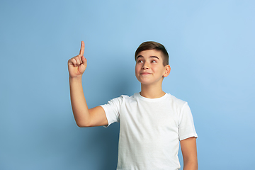 Image showing Caucasian teen\'s portrait isolated on blue studio background