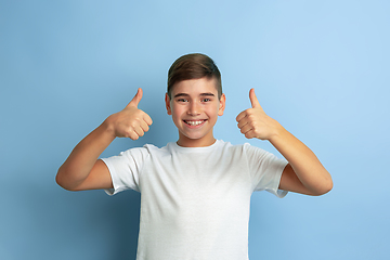 Image showing Caucasian teen\'s portrait isolated on blue studio background