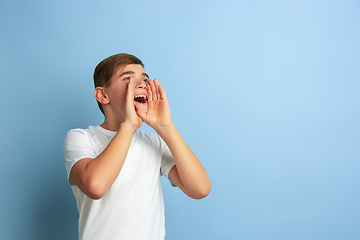 Image showing Caucasian teen\'s portrait isolated on blue studio background