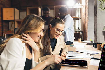 Image showing Colleagues working together in modern office using devices and gadgets during negotiations