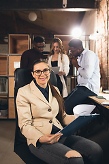 Image showing Colleagues working together in modern office using devices and gadgets during negotiations