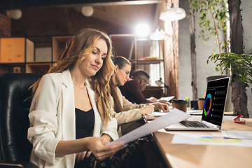 Image showing Colleagues working together in modern office using devices and gadgets during negotiations