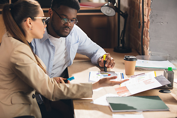 Image showing Colleagues working together in modern office using devices and gadgets during negotiations