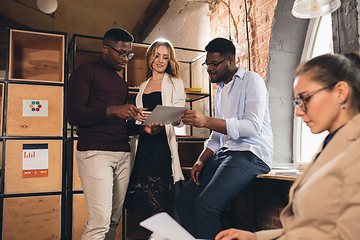 Image showing Colleagues working together in modern office using devices and gadgets during negotiations