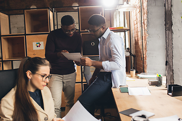 Image showing Colleagues working together in modern office using devices and gadgets during negotiations