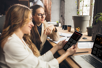 Image showing Colleagues working together in modern office using devices and gadgets during negotiations