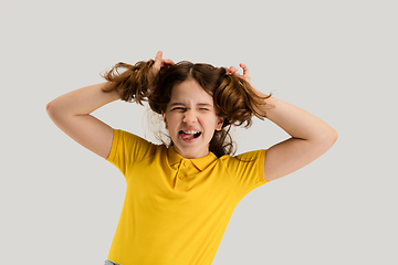 Image showing Caucasian girl isolated on white studio background. Copyspace. Childhood, education, emotions concept