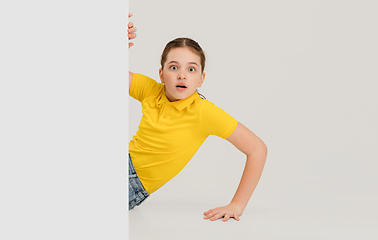 Image showing Caucasian girl isolated on white studio background. Copyspace. Childhood, education, emotions concept