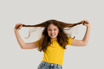 Image showing Caucasian girl isolated on white studio background. Copyspace. Childhood, education, emotions concept