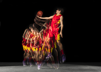 Image showing Young caucasian basketball player in motion and action in mixed light on dark background. Concept of healthy lifestyle, professional sport, hobby.