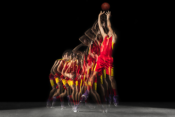 Image showing Young caucasian basketball player in motion and action in mixed light on dark background. Concept of healthy lifestyle, professional sport, hobby.