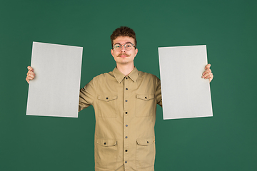 Image showing Caucasian man\'s portrait isolated over green studio background with copyspace