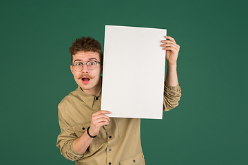 Image showing Caucasian man\'s portrait isolated over green studio background with copyspace