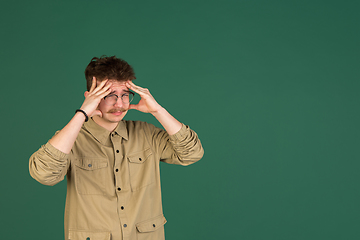 Image showing Caucasian man\'s portrait isolated over green studio background with copyspace