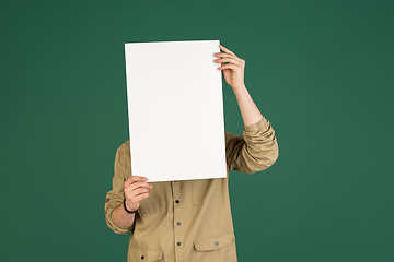 Image showing Caucasian man\'s portrait isolated over green studio background with copyspace