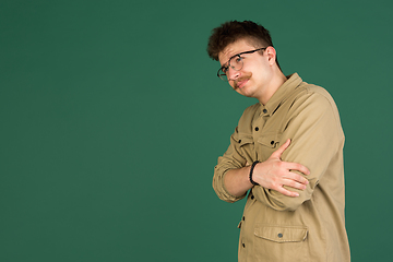 Image showing Caucasian man\'s portrait isolated over green studio background with copyspace