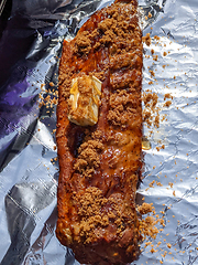 Image showing Close-up view of delicious juicy meat with ribs on grill